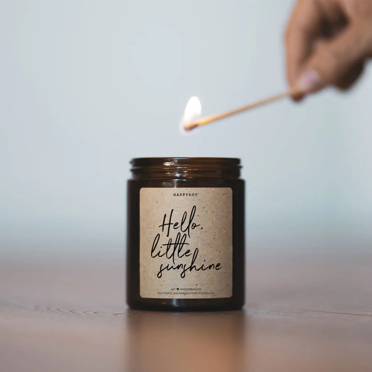 Scented candle with inscription 'Hello little sunshine'